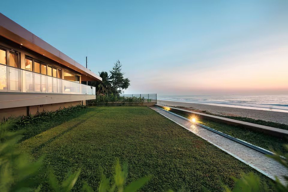 Villa Mer beachfront retreat in Sasihithlu with floor-to-ceiling sliding glass doors overlooking the Arabian Sea